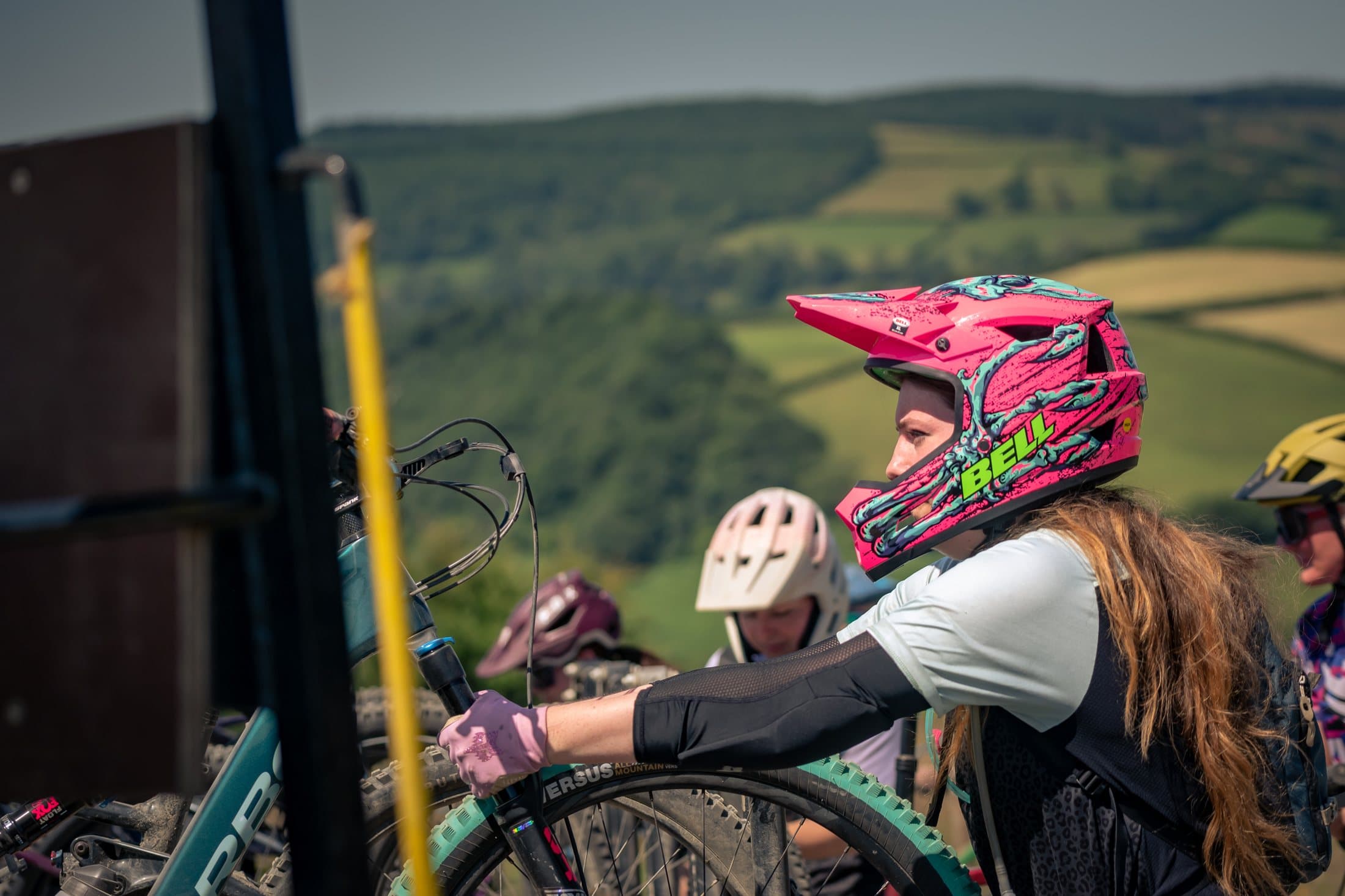 Young riders with bikes and pink helmet waiting at the uplift