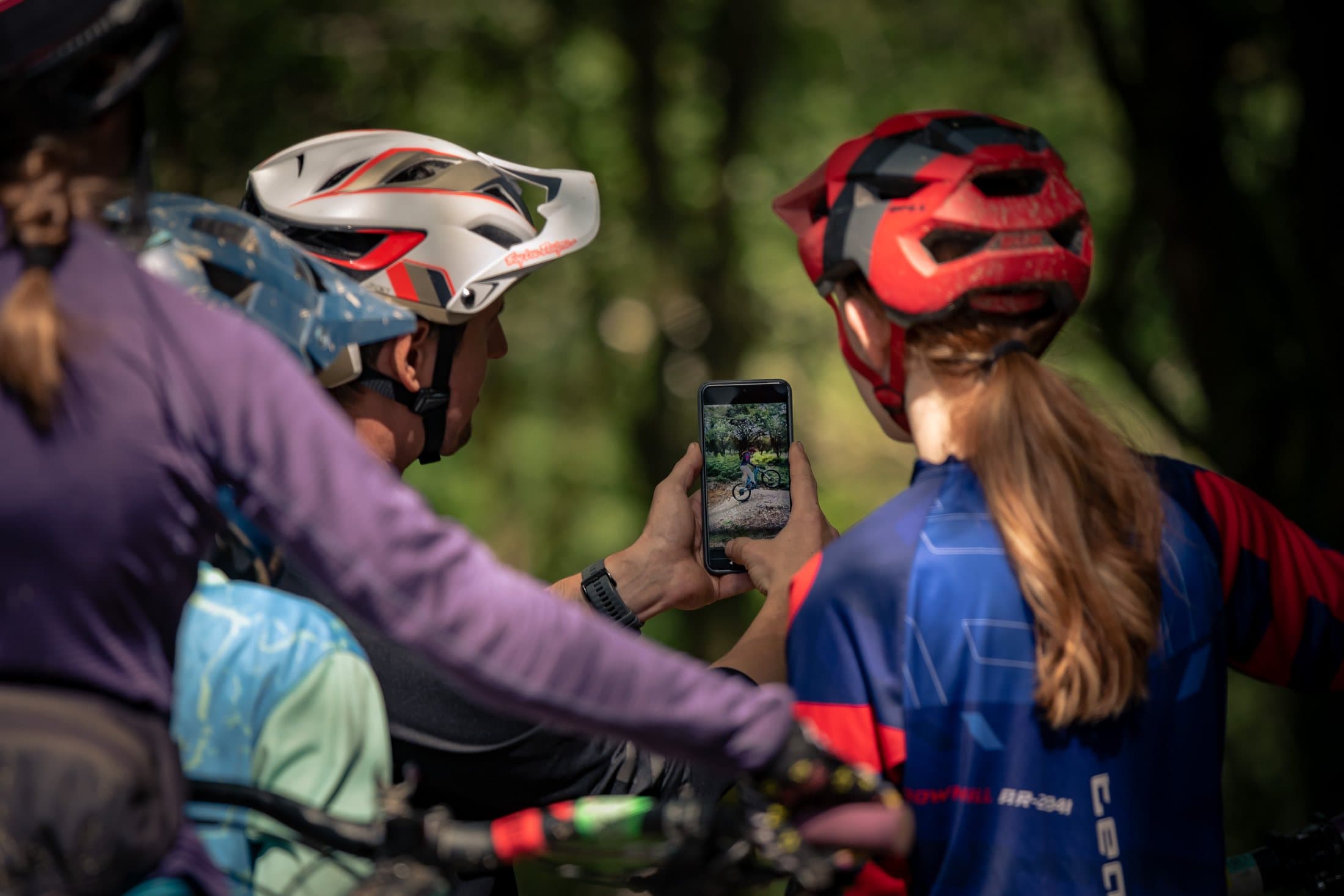 Riders at sign-on looking at a phone, helmets on