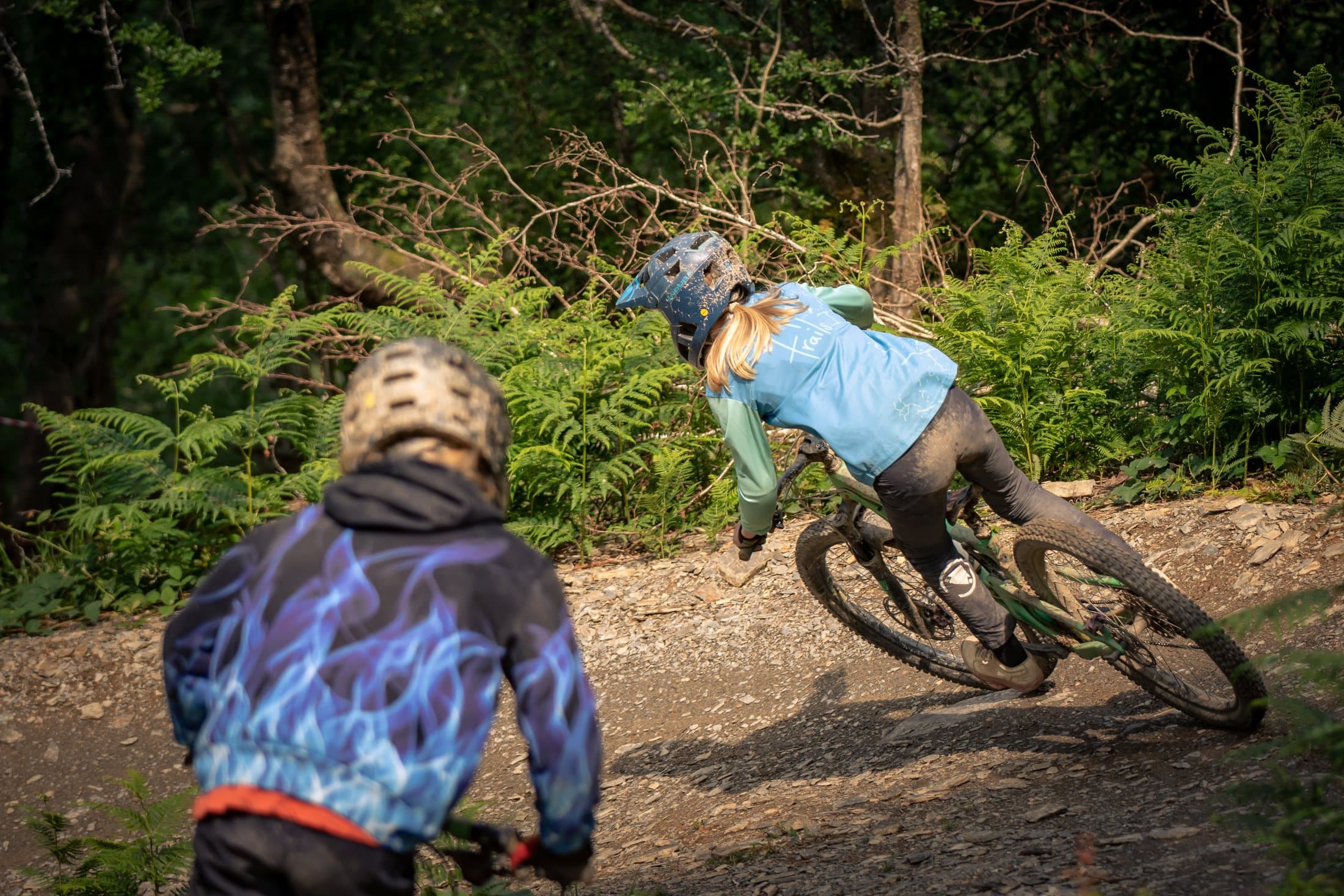 Two riders railing a berm one after the other
